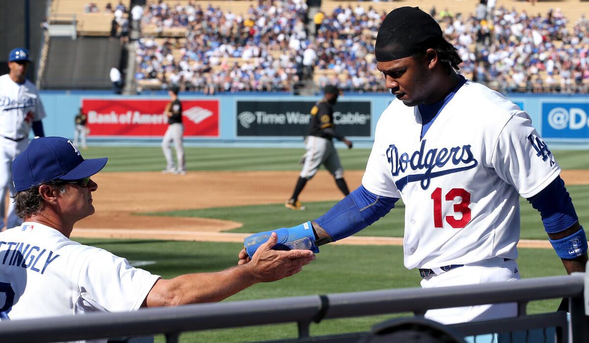 Dodgers shortstop Hanley Ramirez is greeted by Manager Don Mattingly after scoring against the Pirates in the first inning Saturday at Dodger Stadium.