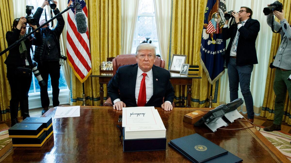 President Donald Trump in the Oval Office after signing the tax bill on Dec. 22, 2017.