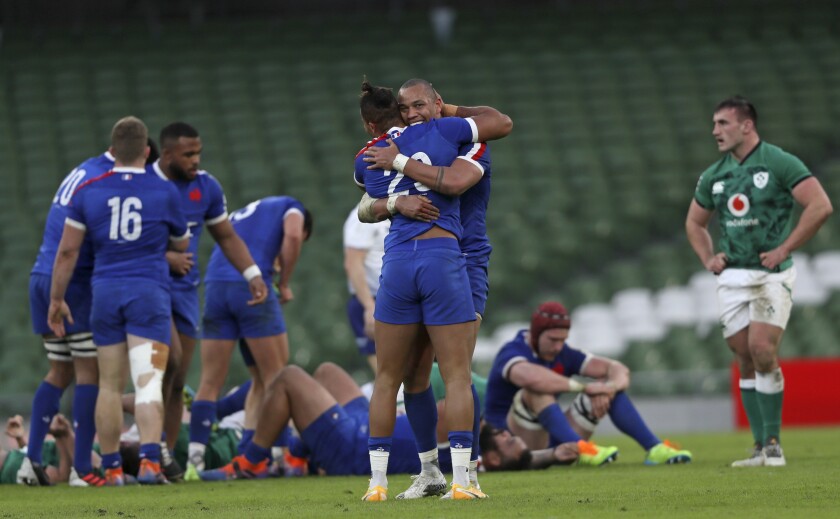 Gael Fickou and Teddy Thomas of France celebrate at the end of the Six Nations rugby union match between Ireland and France Aviva Stadium, Dublin, Sunday, Feb. 14, 2021. France won the match 15-13. (Brian Lawless, Pool via AP)