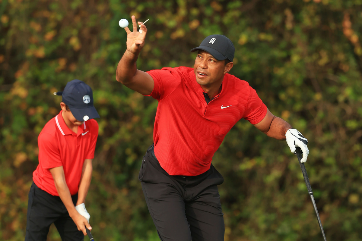 Tiger Woods and his son, Charlie, warm up on the range prior to the final round of the PNC Championship.