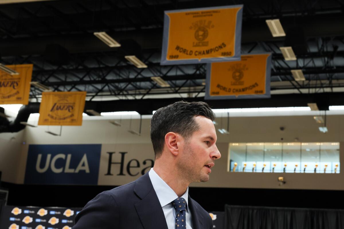 JJ Redick talks to reporters Monday after he was introduced as the Lakers' new head coach at the team's training facility.