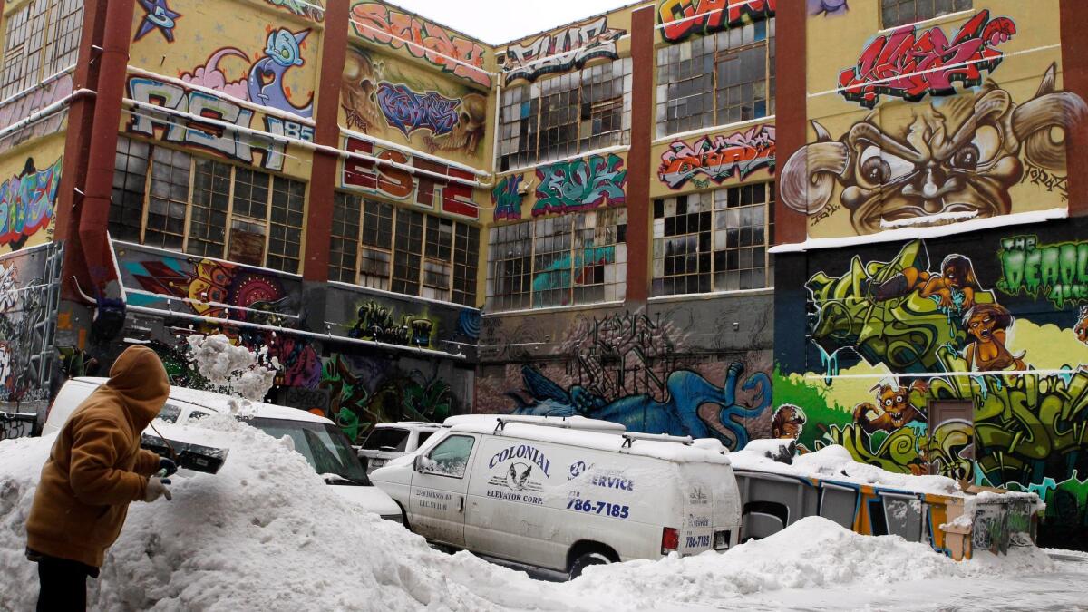 A man shovels snow by the warehouses that were known as 5Pointz in January 2011.