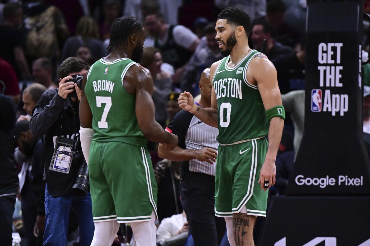 Celtics forward Jayson Tatum congratulates guard Jaylen Brown after they beat the Cleveland Cavaliers on May 13.