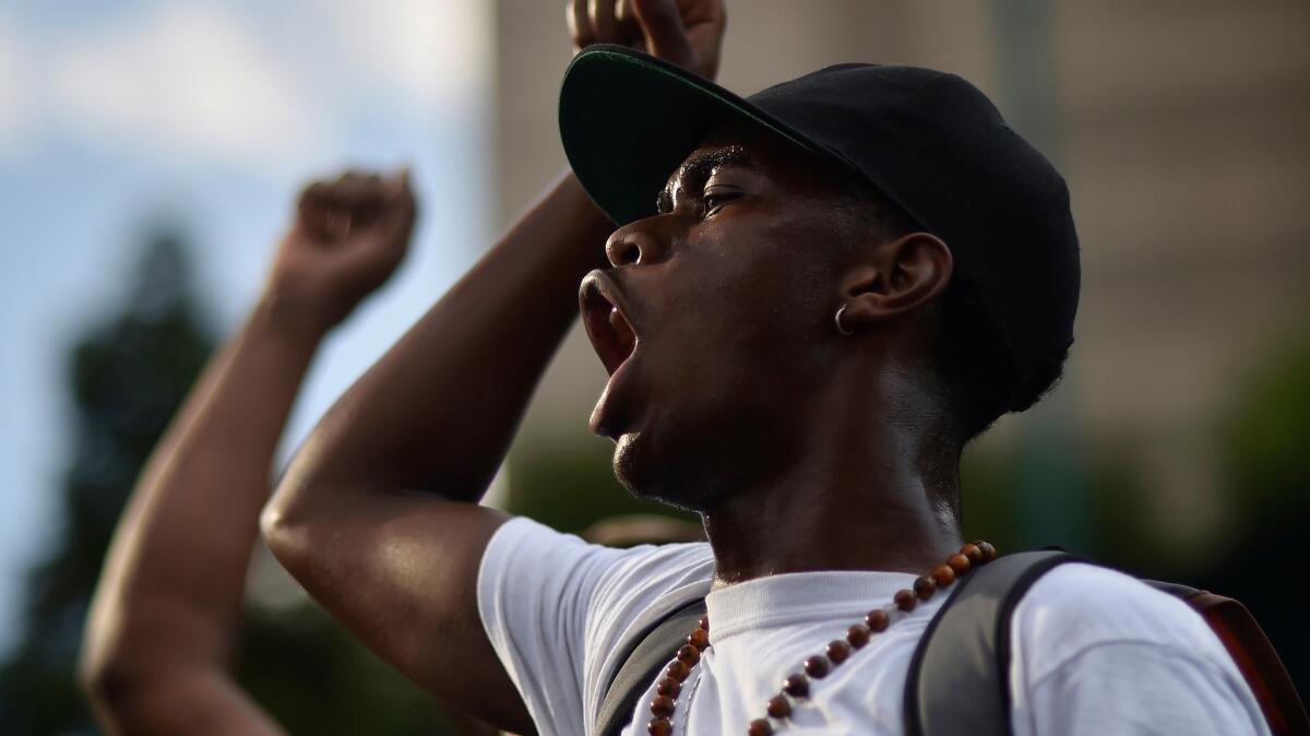 Protesters march in downtown Atlanta in response to fatal police shootings of African American men in Minnesota and Louisiana.