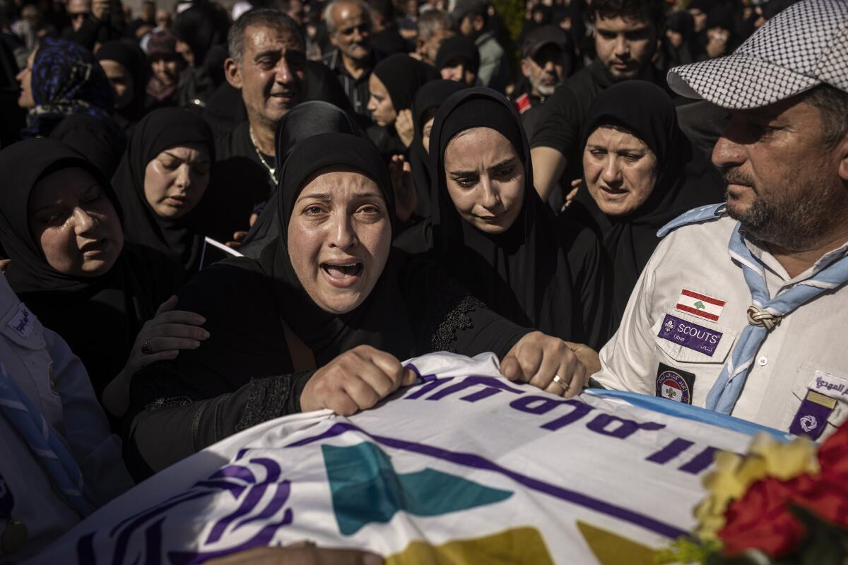 Relatives of three girls killed Sunday in an Israeli airstrike attend their burial in Blida, Lebanon.