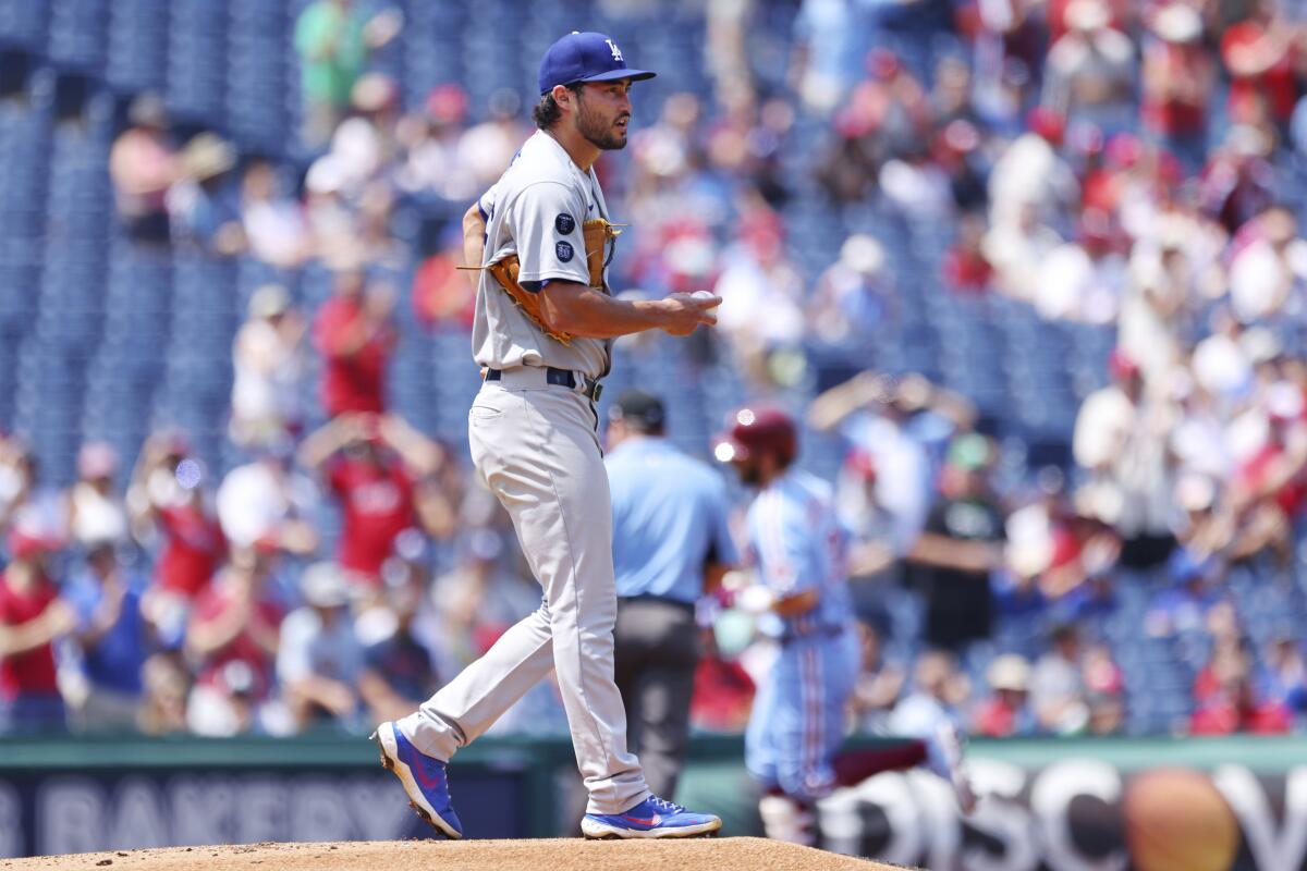 Dodgers pitcher Mitch White looks out as the Phillies' Bryce Harper circles the bases after hitting a home run.