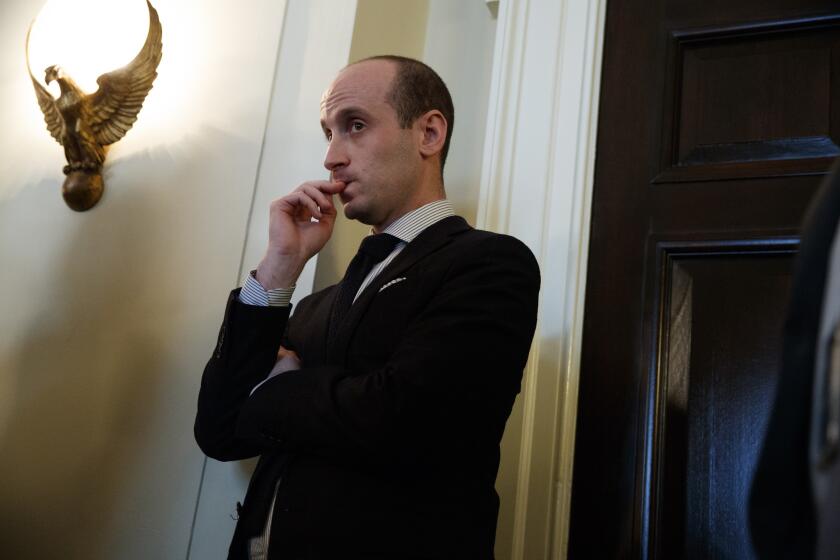Senior White House advisor Stephen Miller listens as President Trump speaks during a meeting with lawmakers at the White House on Jan. 9.