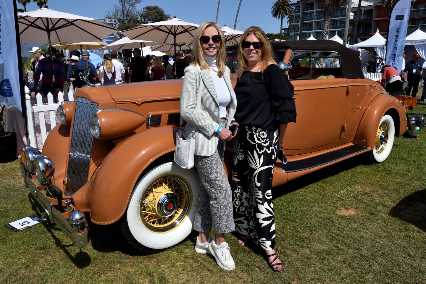 Two friends pose with a 1936 Packard 1404 Convertible Coupe