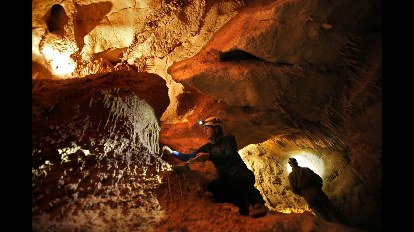Randi Poer of Santa Ana, left, and Paul Kemp of Sandy, Utah, clean lint off rock formations inside Lehman Cave at the Great Basin National Park in Baker, Nev.