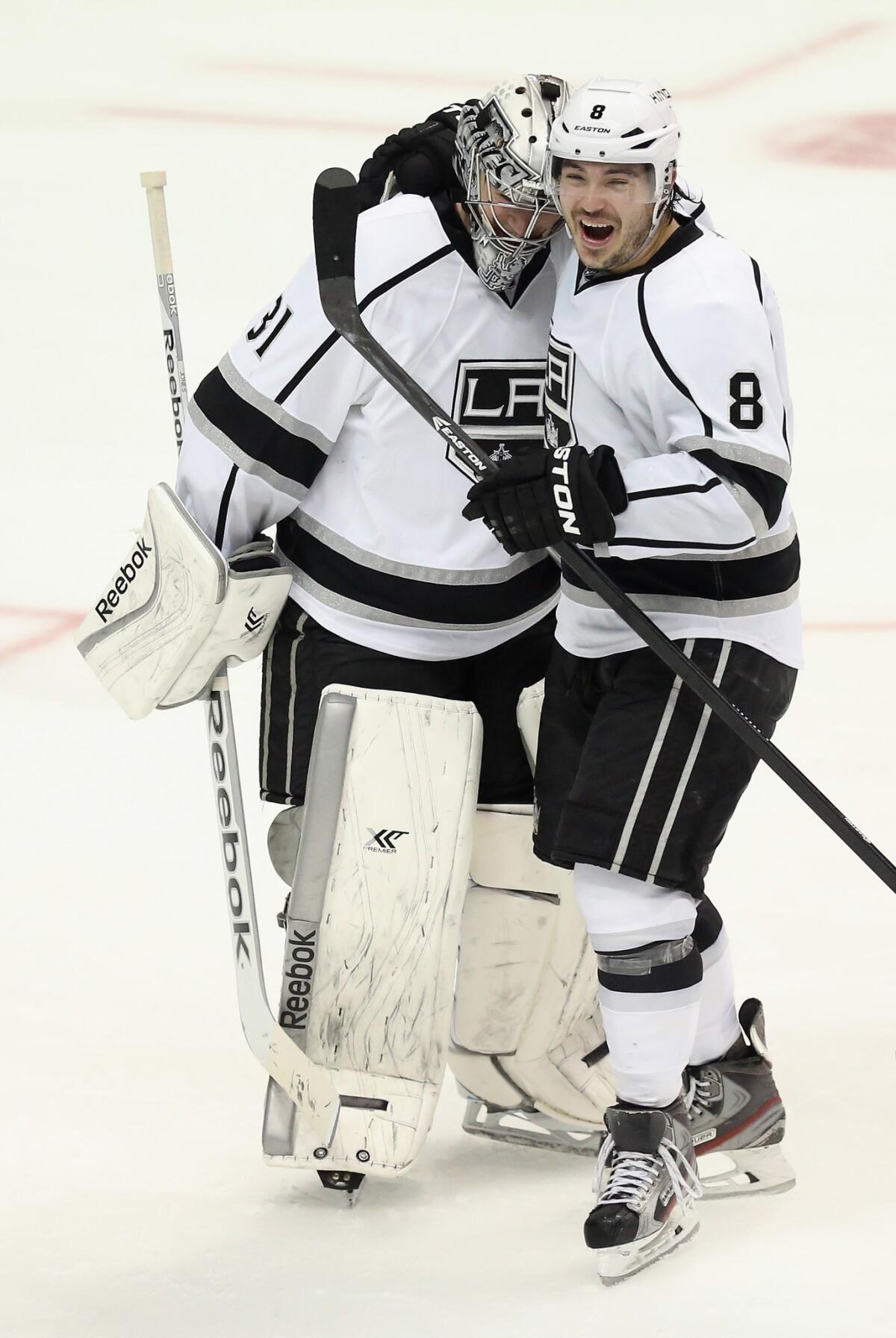 Kings goalie Martin Jones is congratulated by teammate Drew Doughty following the Kings' 3-2 shootout win over the Ducks on Tuesday.