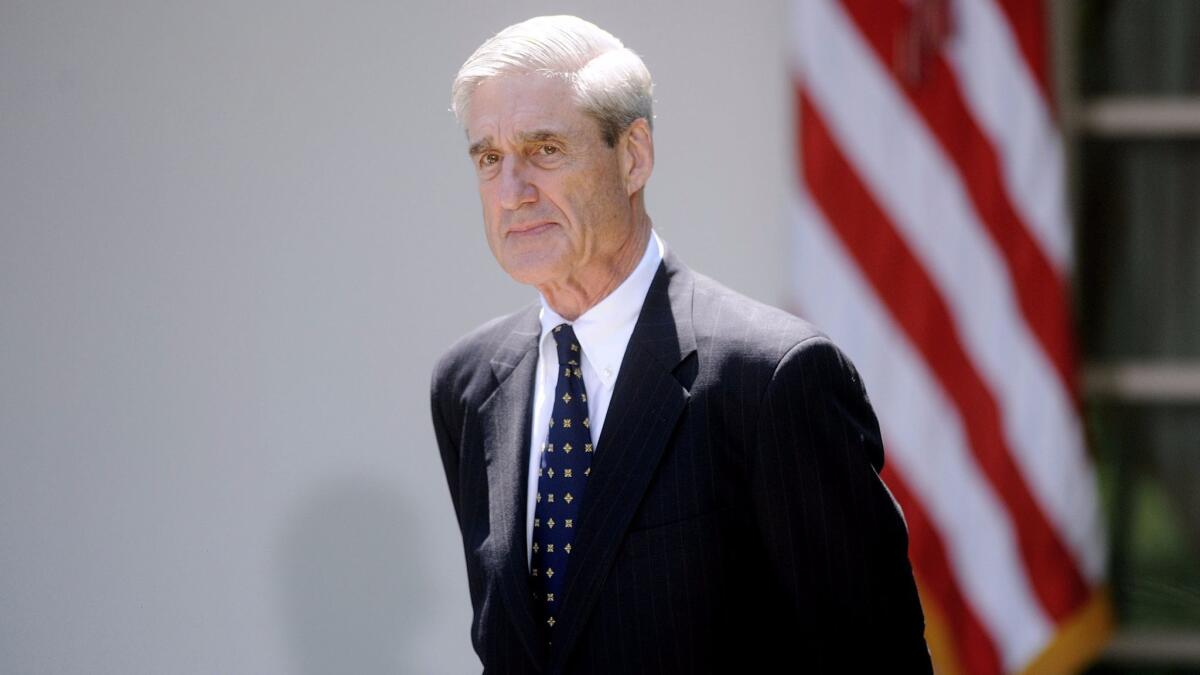 Robert S. Mueller III, then FBI director, looks on during a news conference in the White House Rose Garden in June 2013.