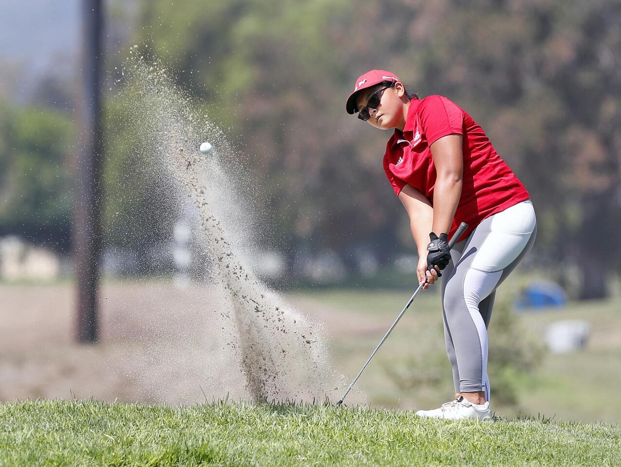 Burroughs Kiara Hernandez chips out of the bunker at the first green a Pacific League golf match at Santa Anita Golf Course in Arcadia on Wednesday, September 4, 2018. Teams from Burroughs, Burbank, Glendale, Crescenta Valley, and Arcadia participated.