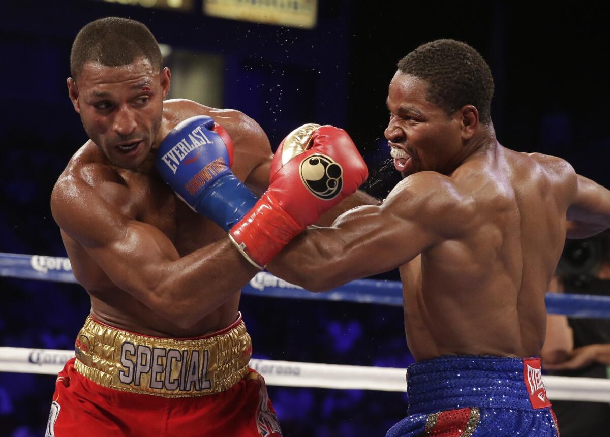 Kell Brook and Shawn Porter trade punches during their IBF welterweight title boxing match Saturday at StubHub Center in Carson, Calif.