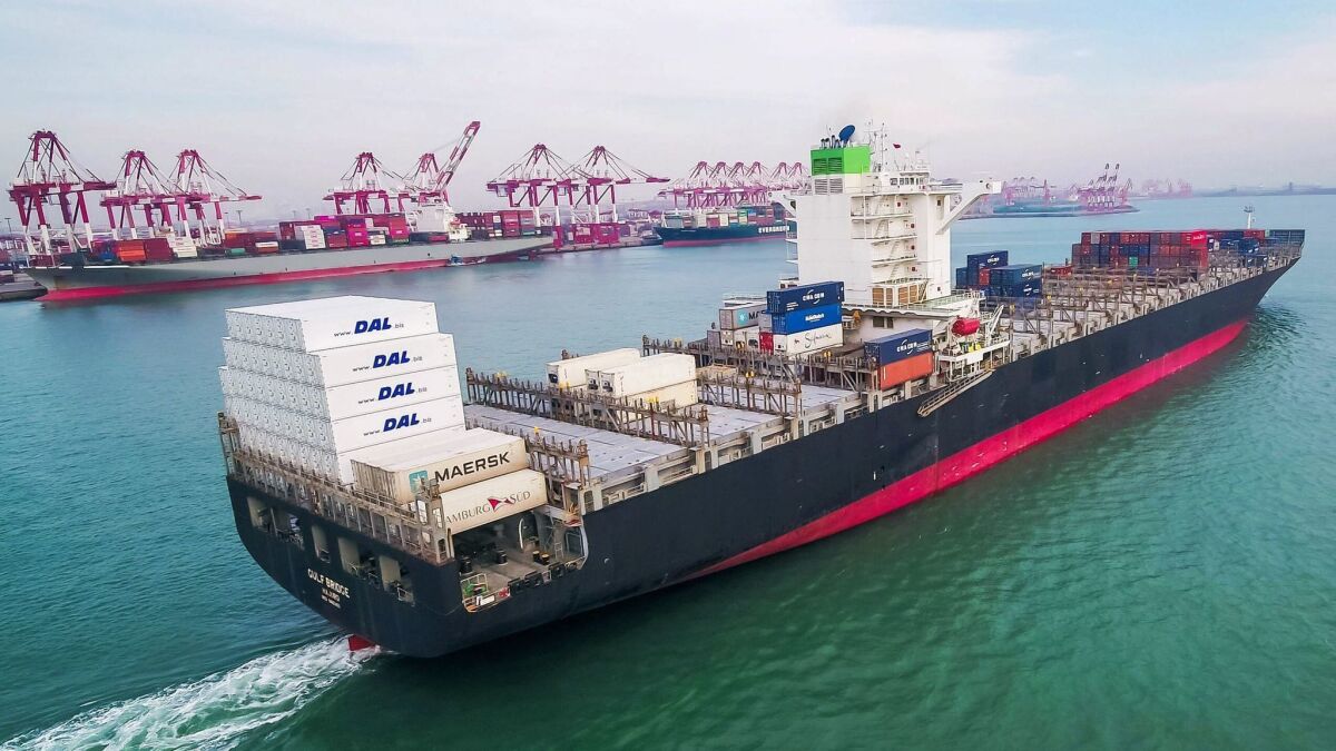 A cargo ship sails near a port in Qingdao in China's eastern Shandong province. U.S. retailers have stepped up purchases of Chinese products to avoid pending tariffs.