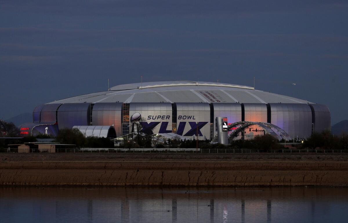 The Super Bowl XLIX logo is displayed on the University of Phoenix Stadium in Glendale, Ariz., site of this year's game.
