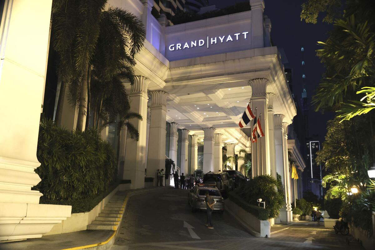 A man walks outside the Grand Hyatt Erawan Hotel in Bangkok, Thailand