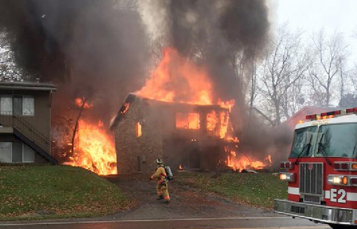 An apartment building in Akron, Ohio, burns after being struck by a jet. All nine aboard the jet were reportedly killed.
