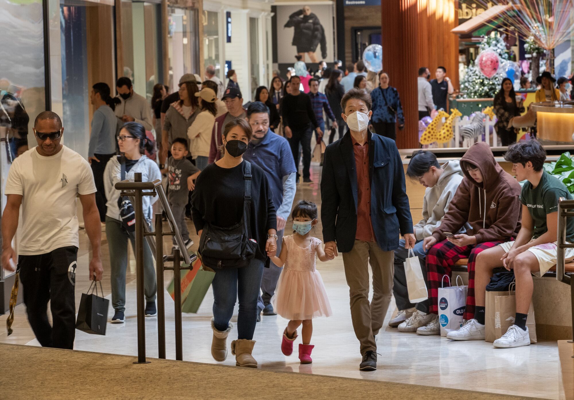 Shoppers look for deals at South Coast Plaza in Costa Mesa on Friday.