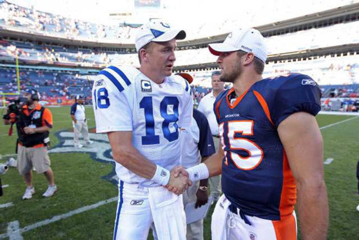 Indianapolis Colts quarterback Peyton Manning, left, greets Denver Broncos quarterback Tim Tebow in 2010.