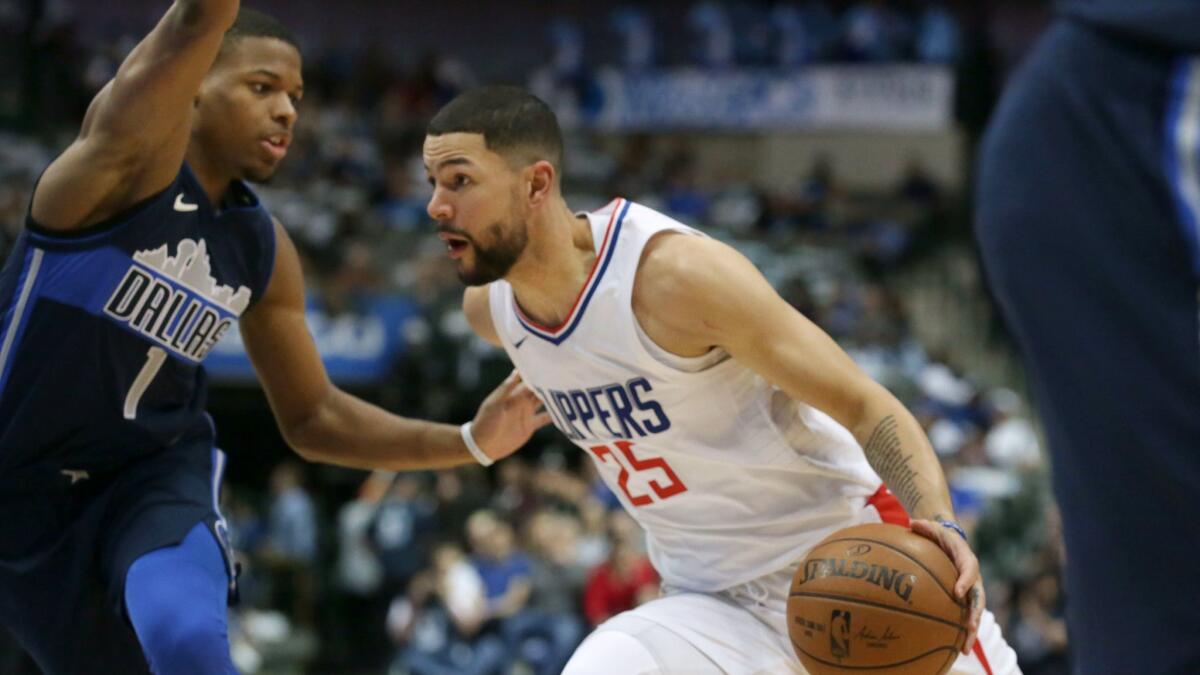 Austin Rivers drives against Dallas Mavericks guard Dennis Smith Jr.