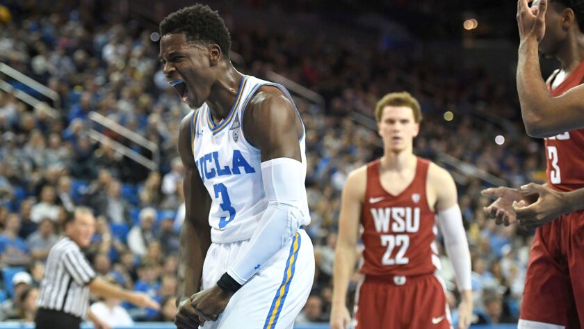 UCLA's Aaron Holiday reacts after being fouled while making a basket during the first half against Washington State.