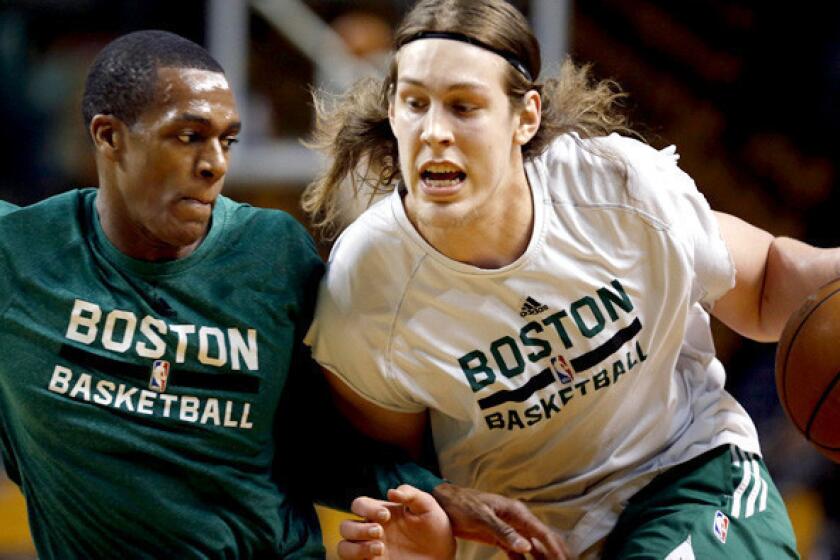 Celtics point guard Rajon Rondo, left, guards teammate Kelly Olynyk during a workout before a game last month against the Minnesota Timberwolves in Boston.