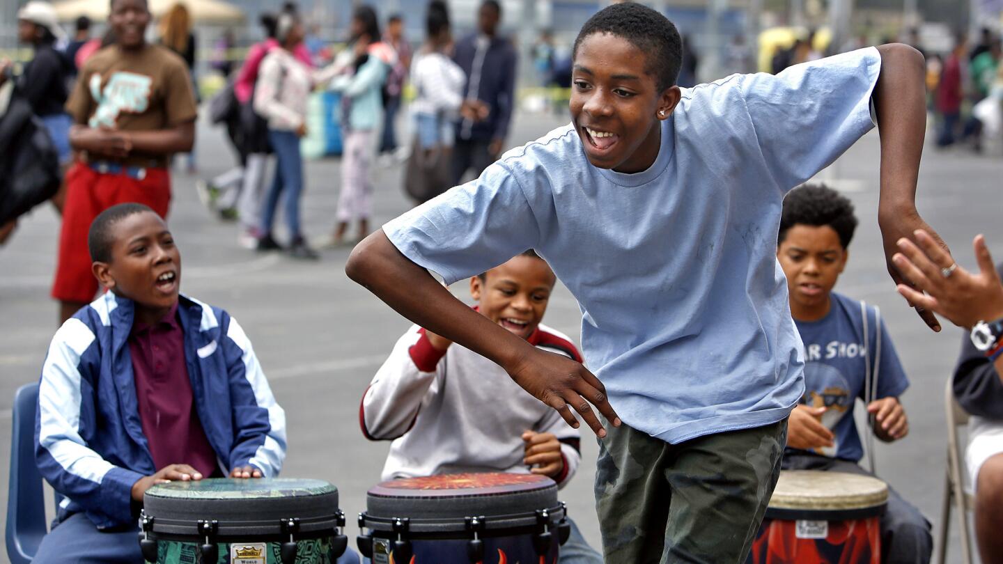 Patrick Bryant, 14, an eighth-grader at Gompers Middle School in South Los Angeles, dances inside a drum circle during a school carnival celebrating "peace week," a program to improve behavior and reduce discipline problems.