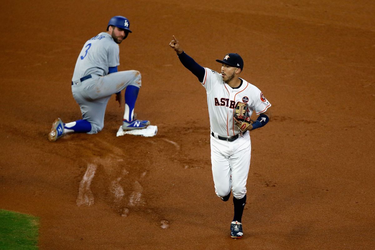 Carlos Correa celebrates after tagging out Dodger Chris Taylor