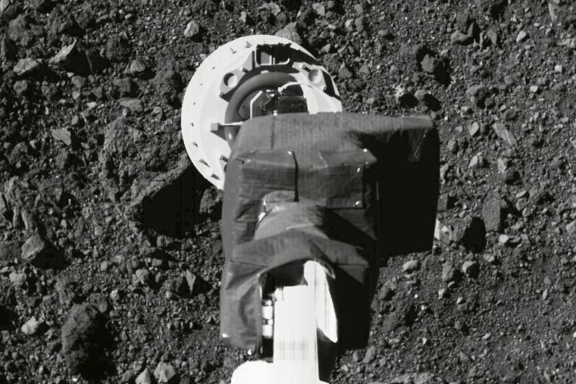 The sampling arm of the OSIRIS-REx spacecraft as it practices its approach to Bennu 