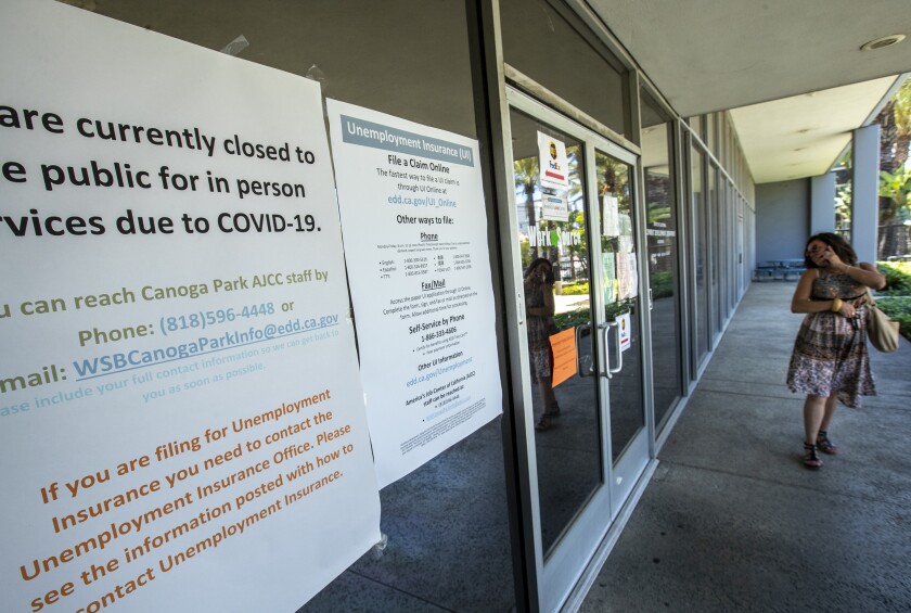 Amy Garcia looks in the window of a closed California State Employment Development Department office