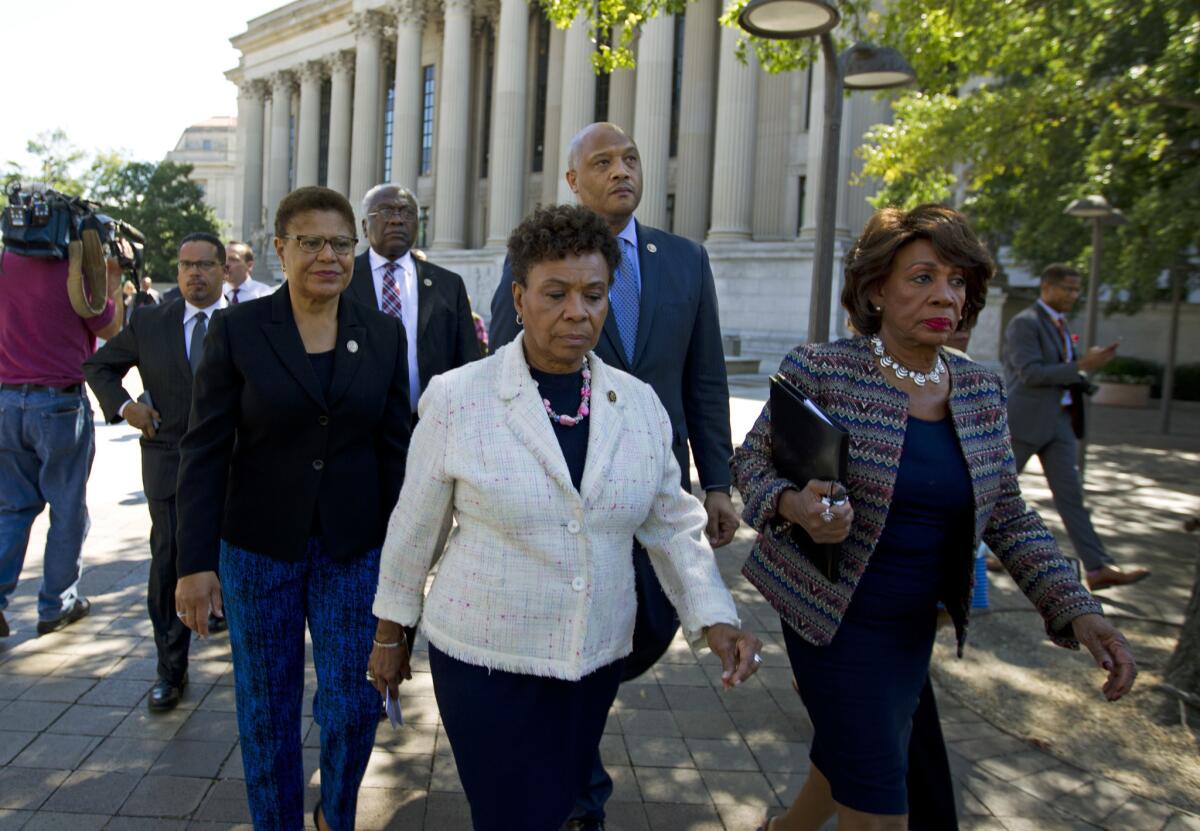 From left, Reps. Karen Bass, Barbara Lee and Maxine Waters of California walk toward the Justice Department.