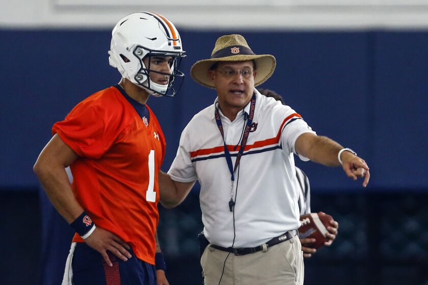 Quarterback Joey Gatewood gets some instruction from coach Gus Malzahn during Auburn's first practice, Friday, Aug. 2, 2019, in Auburn, Ala. (AP Photo/Butch Dill)
