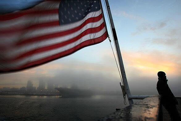 At the crack of dawn, jet fighter pilot Ryan McLaughlin, 35, rides the ferry Cabrillo across foggy San Diego Bay to North Island Naval Air Station on Coronado. After a decade, the free boat service from the Broadway Pier for military and civilian employees at the base will end Friday because of security concerns.