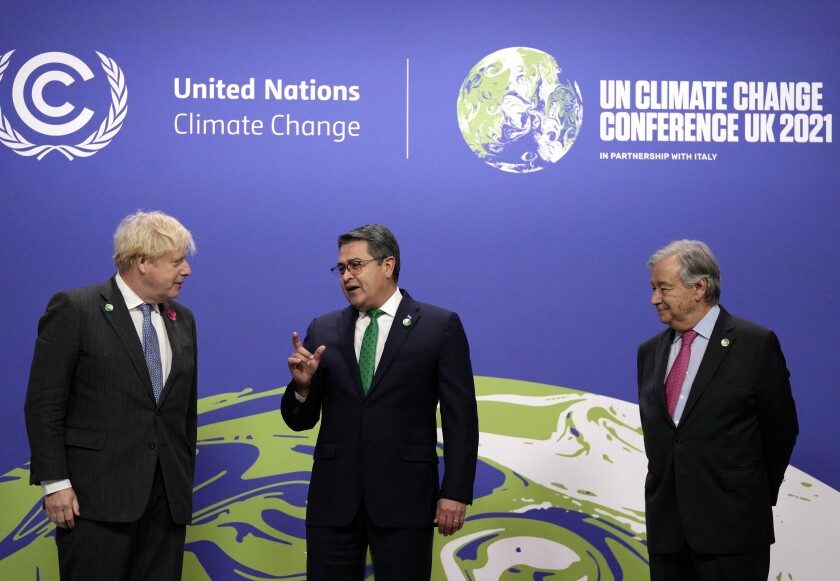 Prime Minister Boris Johnson and U.N. Secretary General Antonio Guterres greet Honduras' President Juan Orlando Hernandez