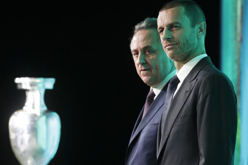 FILE - UEFA President Aleksander Ceferin, foreground, and Vitaly Mutko, Russia's deputy prime minister in charge of sport, tourism and youth policies attend the launch ceremony of a logo for the Euro 2020 soccer championship in St.Petersburg, Russia, Thursday, Jan. 19, 2016. In recent years, UEFA and its president Aleksander Ceferin were praised for blocking projects — a $25 billion deal for new global competitions, biennial World Cup, a European Super League — either pushed by FIFA or discreetly supported by its president Gianni Infantino. UEFA values are being questioned on issues where FIFA has publicly stood firm: Russia and ousted Spanish soccer official Luis Rubiales. (AP Photo/Dmitri Lovetsky)