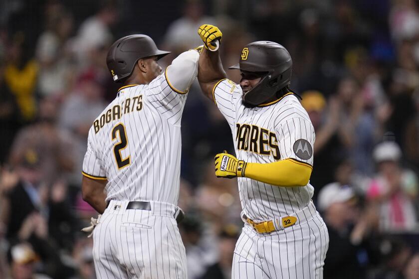 San Diego Padres' Eguy Rosario, right, celebrates with teammate Xander Bogaerts after hitting a home run during the fourth inning of a baseball game against the Colorado Rockies, Monday, Sept. 18, 2023, in San Diego. (AP Photo/Gregory Bull)