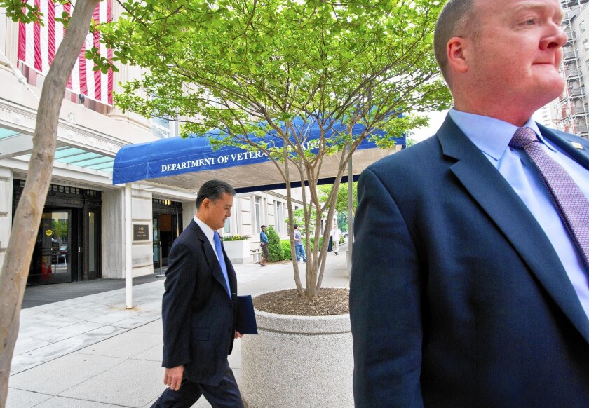 Veterans Affairs Secretary Eric K. Shinseki, left, leaves his office in Washington on his way to the White House.