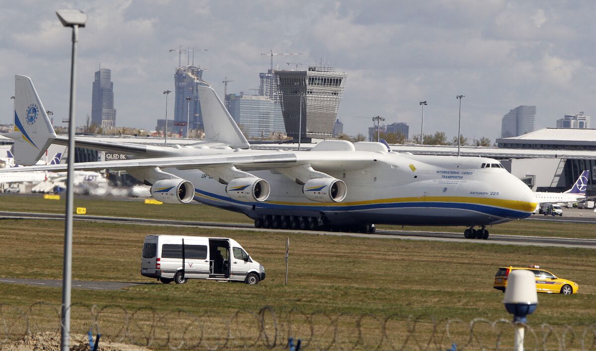 FILE - The now-destroyed world's largest cargo plane, the Soviet-made Antonov An-225 Mriya that belonged to Ukraine, lands at the Frederic Chopin airport, in Warsaw, Poland, April 14, 2020. Poland's air travel authorities are warning travelers of possible flight delays and cancellations at Warsaw's airport due to a protest and some flight controllers quitting their jobs. Mriya was destroyed during Russian shelling of an airport near Kyiv in February. (AP Photo/Czarek Sokolowski, File)