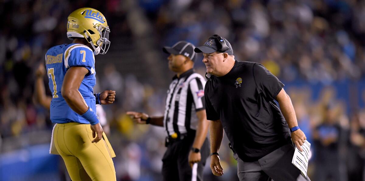 UCLA coach Chip Kelly speaks with quarterback Dorian Thompson-Robinson during a game against Fresno State last year.