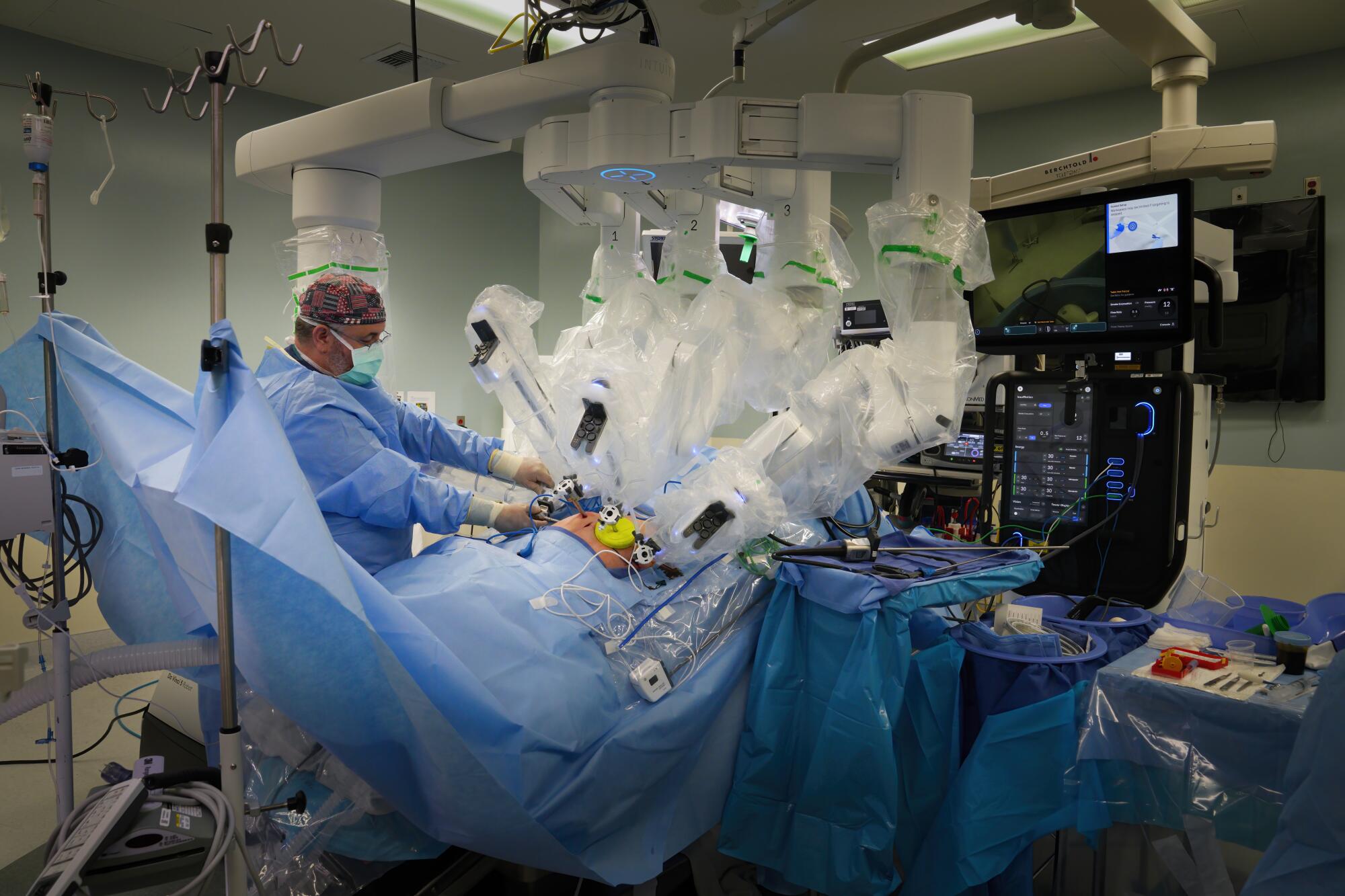 Lead Surgical Assistant, Carl Petty attaches one of the Da Vinci 5 instruments during surgery.