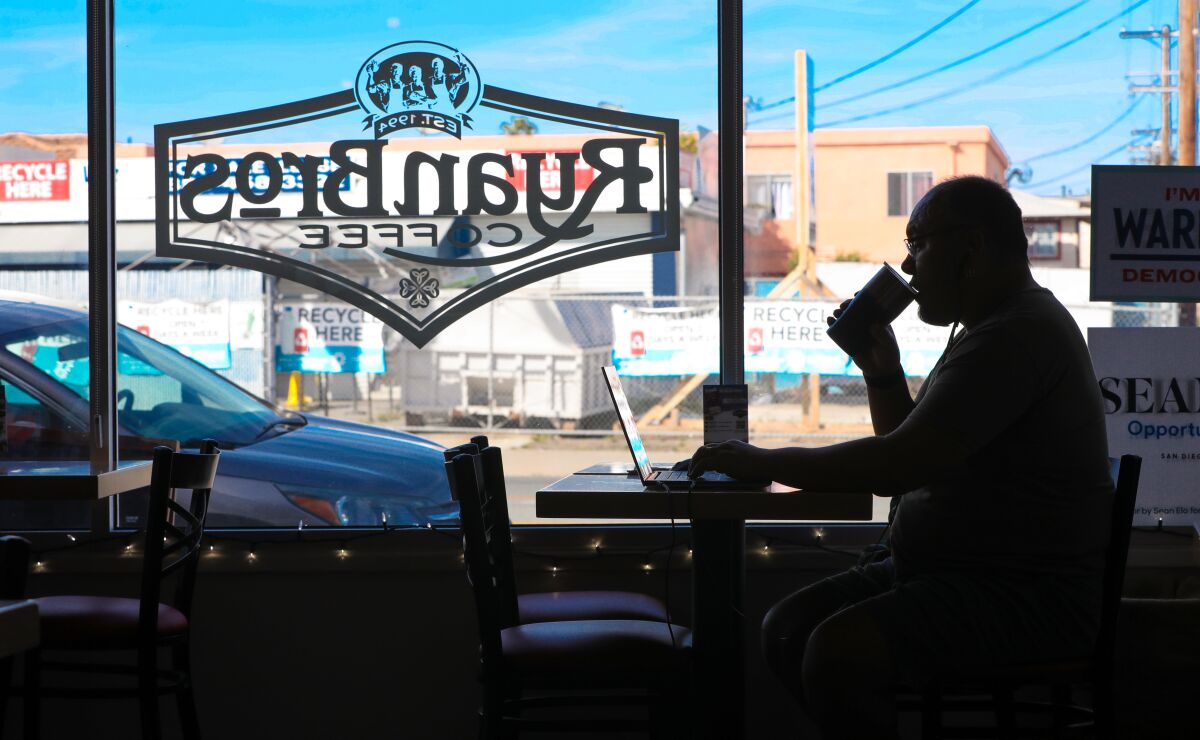 Craig Moreno works on his computer while visiting the Ryan Brothers Coffee location on University Avenue in City Heights on March 5, 2020.