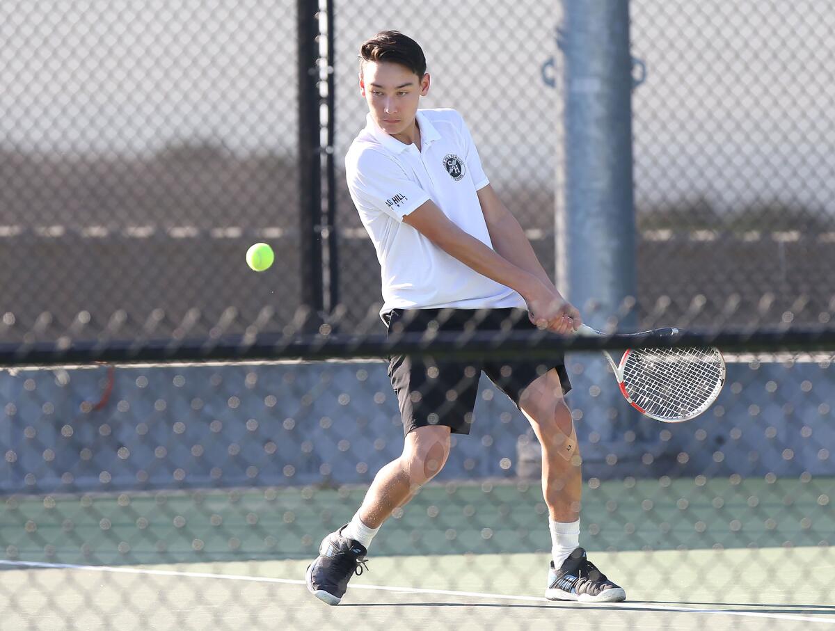 Sage Hill freshman singles player Grant Gallagher steps into a backhand return in a season opener at home against Newport Harbor on Tuesday in Newport Beach.