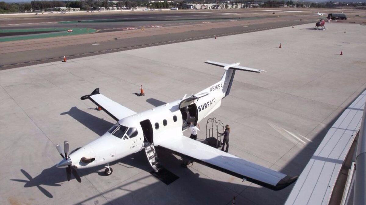 A Surf Air plane parked at McClellan-Palomar Airport in Carlsbad, Calif., is shown. Surf Air has acquired a Texas competitor, Rise.