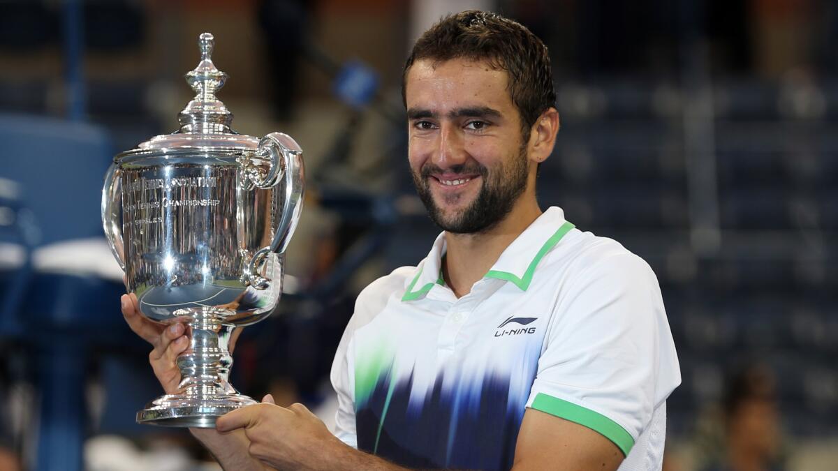 Marin Cilic holds the U.S. Open trophy after defeating Kei Nishikori in the men's final Monday for his first Grand Slam title.