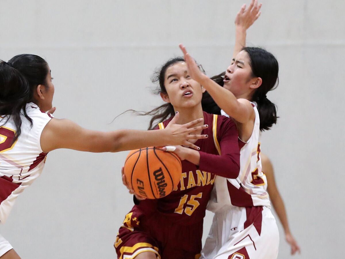 Estancia's Sofia Sihabouj (15) drives between two Ocean View defenders on Wednesday.