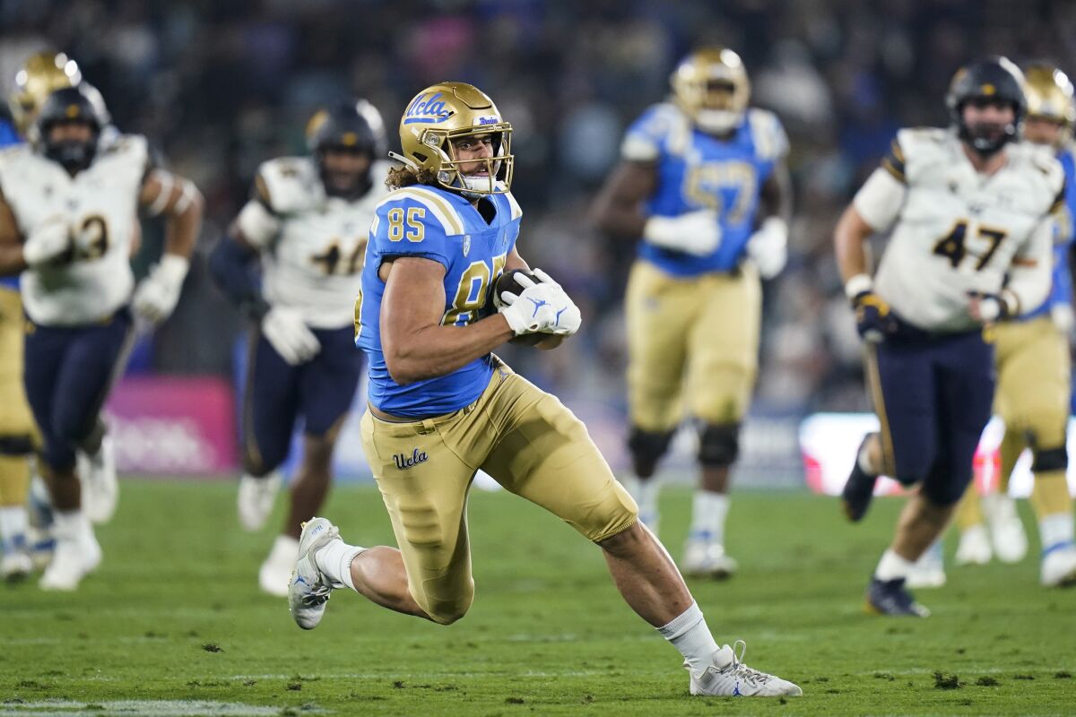 UCLA tight end Greg Dulcich runs with the ball during the first half Nov. 27, 2021.