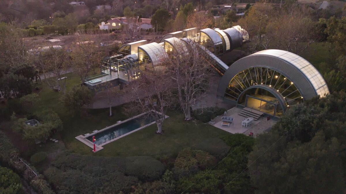 The two-acre estate features a skybridge that connects a 35-foot great room to a long, slender home 