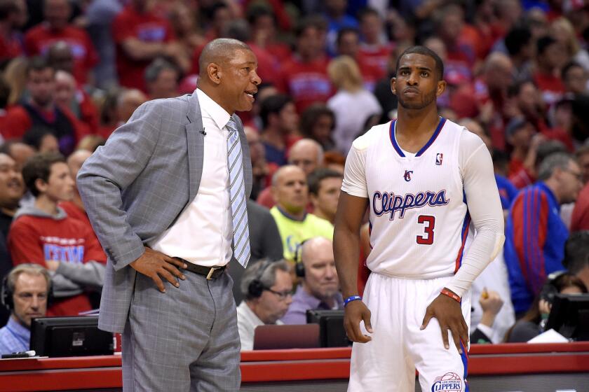 Clippers Coach Doc Rivers talks to point guard Chris Paul during the second half of Game 1 in their playoff series against the Golden State Warriors.