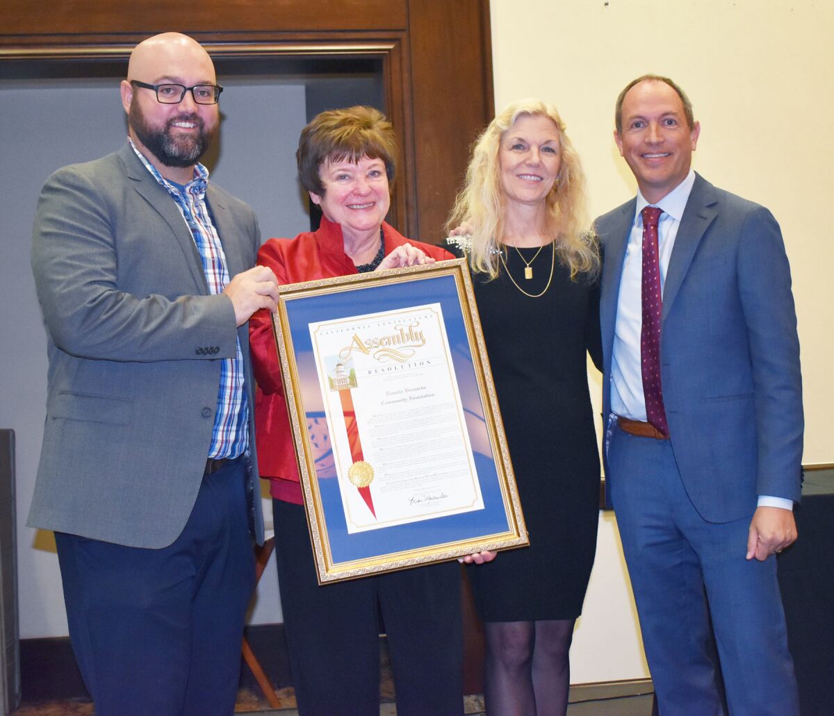 Daniel Wilson, Trudy Armstrong and Debbie Kurth accepting the award from Assemblyman Brian Maienschein.