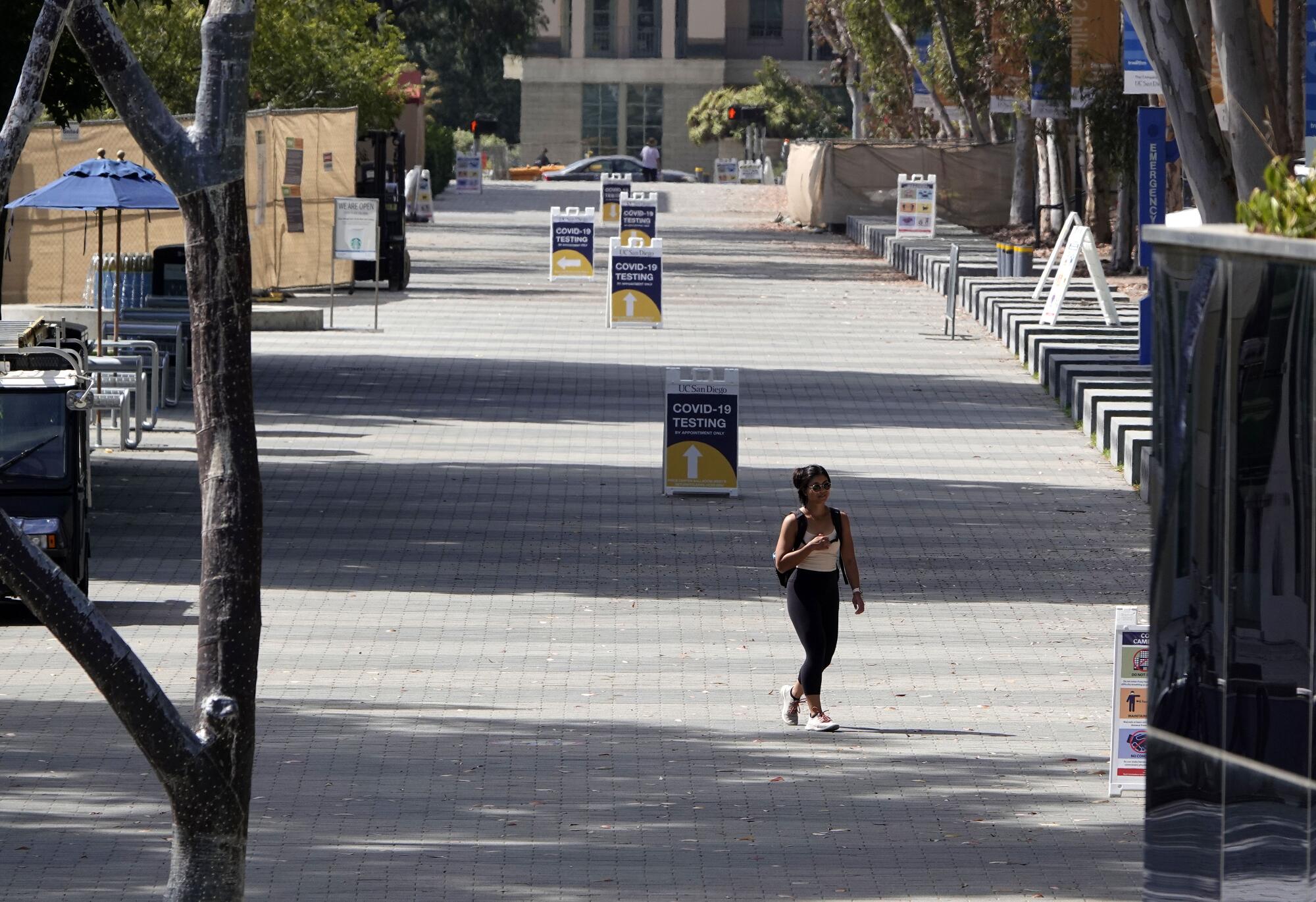 One student walks on an empty campus